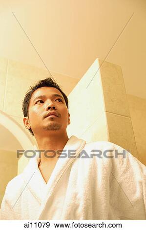 Young man in robe looking away View Large Photo Image Stock Photo - Young man in robe looking away. Fotosearch