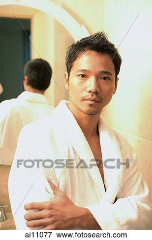 Young man in robe with arms crossed, looking at camera View Large Photo Image Stock Photo - Young man in robe with arms crossed, looking at camera. Fotosearch