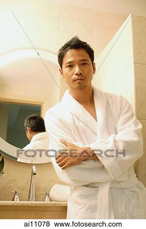 Young man in robe with arms crossed, looking at camera View Large Photo Image Stock Photo - Young man in robe with arms crossed, looking at camera. Fotosearch
