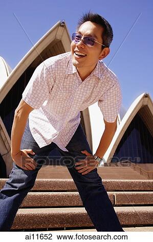 Young man leaning down. hands on legs View Large Photo Image Stock Image - Young man leaning down. hands on legs. Fotosearch