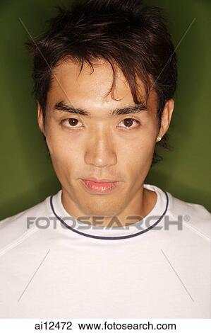 Young man looking at camera, portrait View Large Photo Image Stock Image - Young man looking at camera, portrait. Fotosearch