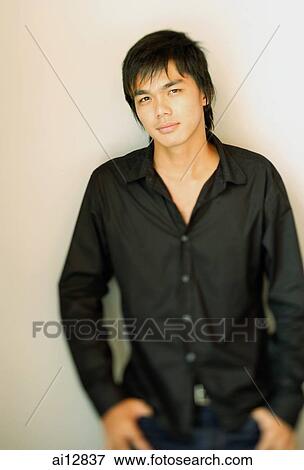 Young man looking at camera, portrait View Large Photo Image Stock Photo - Young man looking at camera, portrait. Fotosearch