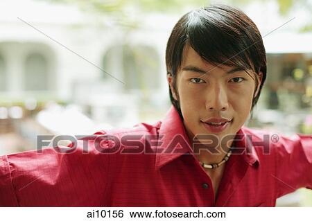 Young man looking at camera, portrait View Large Photo Image Stock Photograph - Young man looking at camera, portrait. Fotosearch