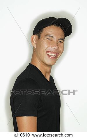 Young man looking at camera, smiling View Large Photo Image Stock Image - Young man looking at camera, smiling. Fotosearch
