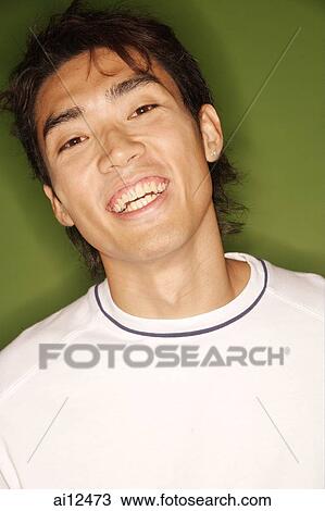 Young man looking at camera, smiling, portrait View Large Photo Image Stock Image - Young man looking at camera, smiling, portrait. Fotosearch