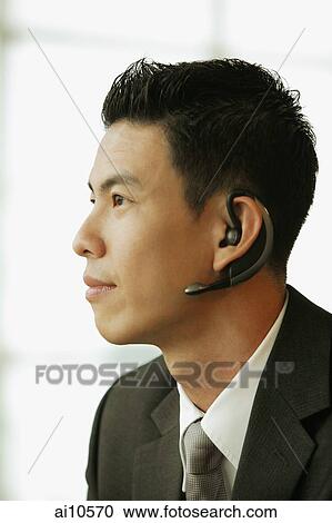 Young man, profile, using hands free device View Large Photo Image Stock Image - Young man, profile, using hands free device. Fotosearch