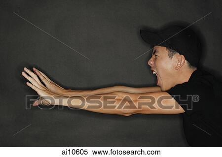 Young man reaching forward, stretching, mouth open View Large Photo Image Stock Photography - Young man reaching forward, stretching, mouth open. Fotosearch