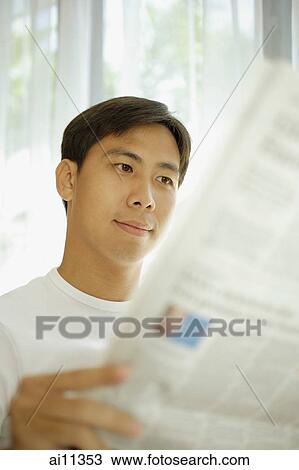 Young man reading newspaper, focus on the background View Large Photo Image Stock Image - Young man reading newspaper, focus on the background. Fotosearch