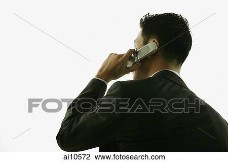 Young man, rear view, on the phone View Large Photo Image Stock Image - Young man, rear view, on the phone. Fotosearch