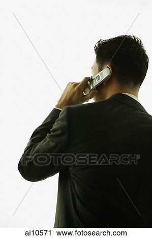 Young man, rear view, using mobile phone View Large Photo Image Stock Image - Young man, rear view, using mobile phone. Fotosearch