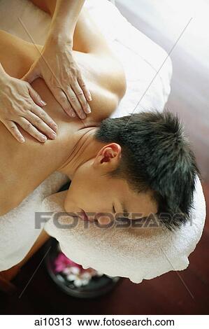 Young man receiving back massage, eyes closed View Large Photo Image Stock Image - Young man receiving back massage, eyes closed. Fotosearch