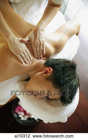 Young man receiving back massage View Large Photo Image Stock Image - Young man receiving back massage. Fotosearch