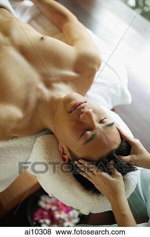 Young man receiving head massage View Large Photo Image Stock Photo - Young man receiving head massage. Fotosearch