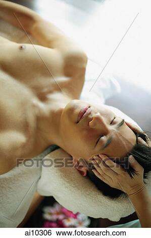 Young man receiving head massage View Large Photo Image Stock Photograph - Young man receiving head massage. Fotosearch