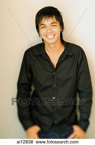 Young man smiling at camera, portrait View Large Photo Image Stock Photo - Young man smiling at camera, portrait. Fotosearch