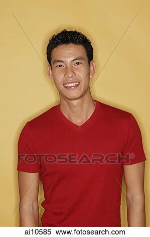 Young man smiling at camera, yellow background View Large Photo Image Stock Photography - Young man smiling at camera, yellow background. Fotosearch