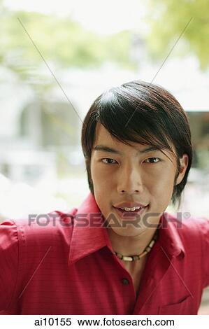 Young man smiling, looking at camera View Large Photo Image Stock Photography - Young man smiling, looking at camera. Fotosearch