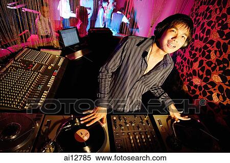 Young man spinning at club, looking up View Large Photo Image Stock Photography - Young man spinning at club, looking up. Fotosearch