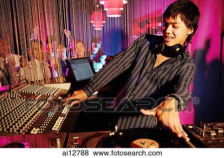 Young man spinning at club View Large Photo Image Stock Photo - Young man spinning at club. Fotosearch