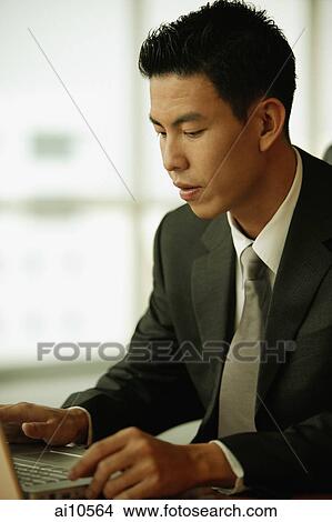 Young man using laptop View Large Photo Image Picture - Young man using laptop. Fotosearch