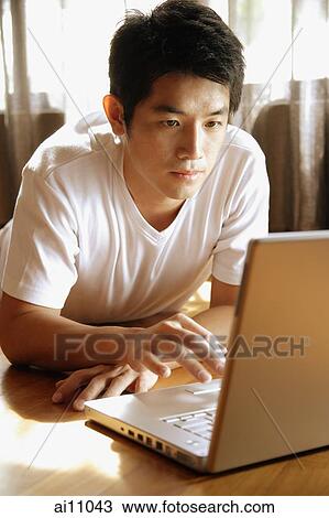 Young man using laptop. View Large Photo Image Stock Image - Young man using laptop.. Fotosearch