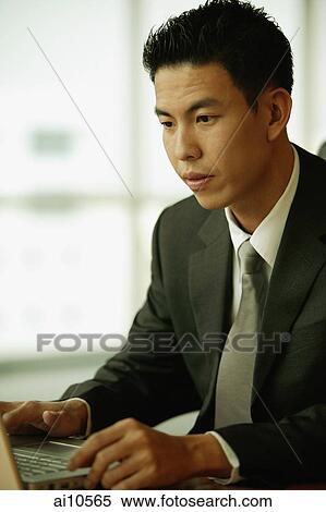 Young man using laptop View Large Photo Image Stock Photography - Young man using laptop. Fotosearch