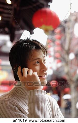 Young man using mobile phone View Large Photo Image Stock Photo - Young man using mobile phone. Fotosearch