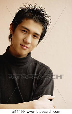 Young man with arms crossed, looking at camera View Large Photo Image Stock Photo - Young man with arms crossed, looking at camera. Fotosearch