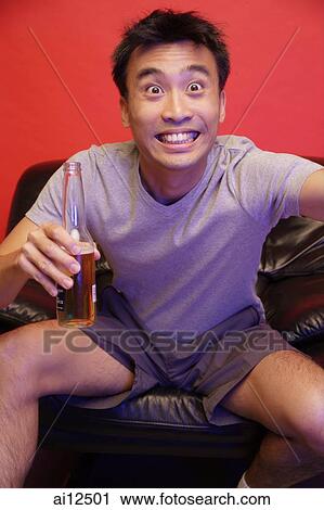 Young man with beer bottle, eyes wide open View Large Photo Image Stock Image - Young man with beer bottle, eyes wide open. Fotosearch