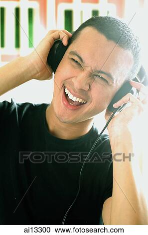Young man with headphones, portrait View Large Photo Image Stock Image - Young man with headphones, portrait. Fotosearch