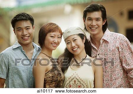 Young men and women smiling at camera View Large Photo Image Stock Photo - Young men and women smiling at camera. Fotosearch
