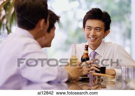 Young men at bar counter with drinks View Large Photo Image Stock Image - Young men at bar counter with drinks. Fotosearch
