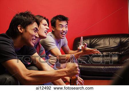Young men holding beer bottles, watching TV View Large Photo Image Stock Image - Young men holding beer bottles, watching TV. Fotosearch