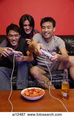 Stock Photo - Young men playing with video games. Fotosearch