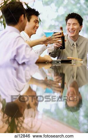 Young men raising drinks for a toast View Large Photo Image Stock Photograph - Young men raising drinks for a toast. Fotosearch