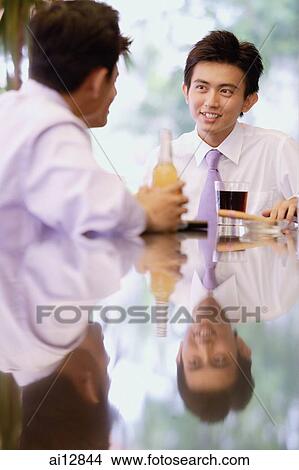 Young men sitting at bar counter with drinks View Large Photo Image Picture - Young men sitting at bar counter with drinks. Fotosearch