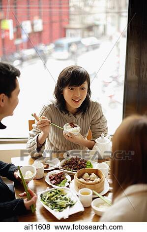 Young woman and friends at a Chinese restaurant View Large Photo Image Stock Photo - Young woman and friends at a Chinese restaurant. Fotosearch