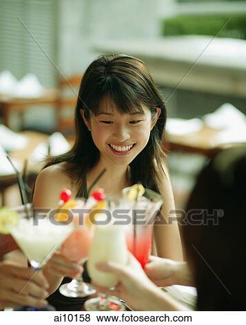 Young woman and friends toasting with drinks. View Large Photo Image Stock Photo - Young woman and friends toasting with drinks.. Fotosearch