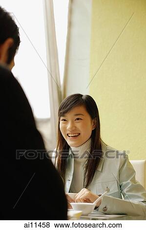 Young woman and young man at a cafe View Large Photo Image Stock Photo - Young woman and young man at a cafe. Fotosearch