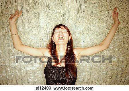 Young woman, arms outstretched, shouting View Large Photo Image Stock Photo - Young woman, arms outstretched, shouting. Fotosearch
