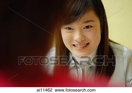 Young woman at a cafe, another young woman in front of her View Large Photo Image Stock Image - Young woman at a cafe, another young woman in front of her. Fotosearch