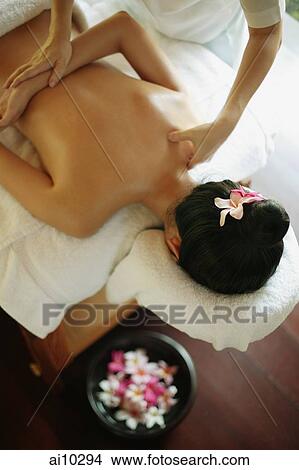 Young woman at a spa, being massaged View Large Photo Image Picture - Young woman at a spa, being massaged. Fotosearch