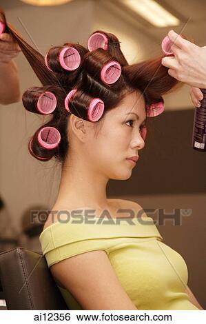 Young woman at beauty salon, getting her hair done View Large Photo Image Stock Photograph - Young woman at beauty salon, getting her hair done. Fotosearch