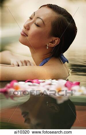 Young woman, at edge of swimming pool, eyes closed View Large Photo Image Stock Image - Young woman, at edge of swimming pool, eyes closed. Fotosearch