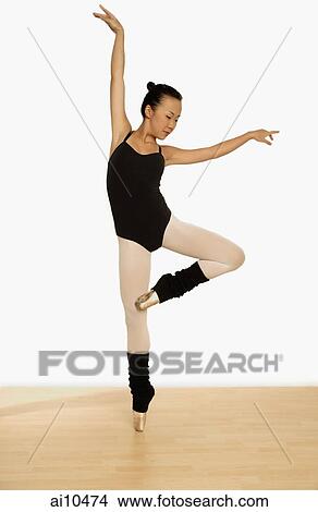 Picture - Young woman balancing on toes.. Fotosearch