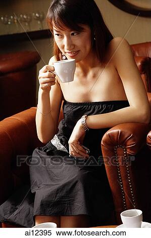 Young woman drinking from cup, looking away View Large Photo Image Stock Photography - Young woman drinking from cup, looking away. Fotosearch