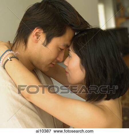 Young woman embracing young man View Large Photo Image Stock Photo - Young woman embracing young man. Fotosearch