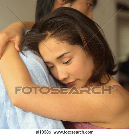 Young woman embracing young man View Large Photo Image Stock Photography - Young woman embracing young man. Fotosearch