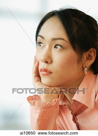 Young woman, hand on chin, looking away View Large Photo Image Stock Image - Young woman, hand on chin, looking away. Fotosearch