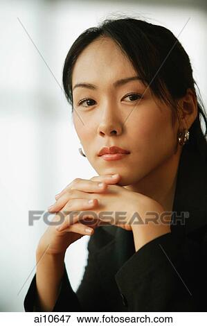 Young woman, hands on chin View Large Photo Image Stock Photo - Young woman, hands on chin. Fotosearch